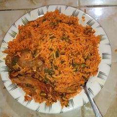 A picture of Jallof rice with fried chicken.