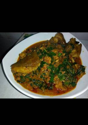 A picture of Banga soup with goat meat and scent leaves.