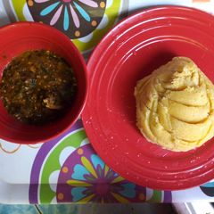A picture of Okro soup with yellow garri.