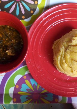 A picture of Okro soup with yellow garri.