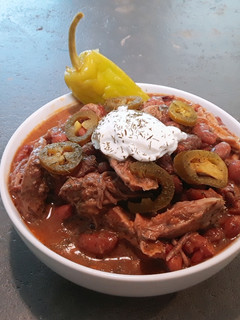 A picture of Creole red beans and rice with slow cooked pulled pork.
