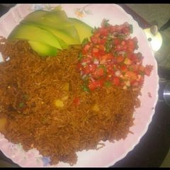 A picture of Pilau with kachumbari.