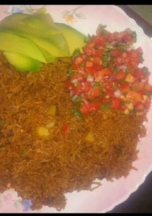 A picture of Pilau with kachumbari.