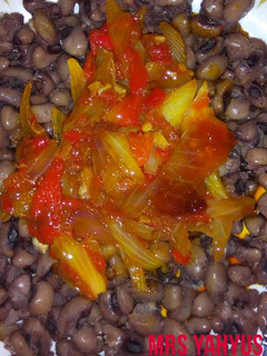 A picture of Beans with red oil pepper and onion sauce.