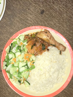A picture of White rice with salad and chicken sauce.