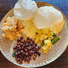 A picture of Halwa Poori, Sookha Kala Chana and Aloo Sabzi.