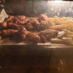 A picture of Baked spicy honey chicken wings with potatoes.