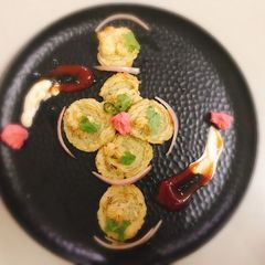 A picture of Parmesan chilli duchess potatoes swirl with red pepper sauce.
