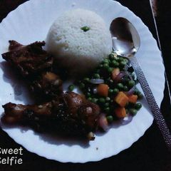 A picture of Boiled rice,mixed vegetables and grilled chicken.