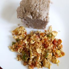 A picture of Fried eggs with Brown Ugali.