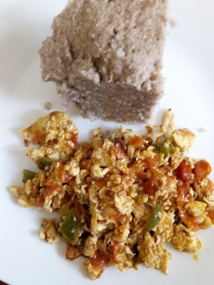 A picture of Fried eggs with Brown Ugali.