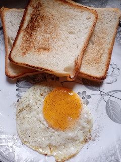 A picture of Half fry Egg With bread.