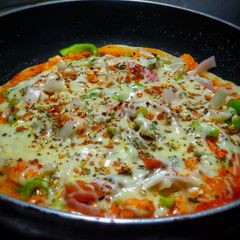 Veg delite pizza on tawa with homemade pizza base A picture of Veg delite pizza on tawa with homemade pizza base.