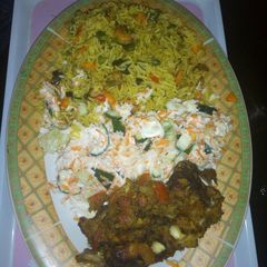 A picture of Fried rice, salad and grilled croaker fisg.