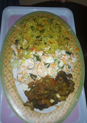 A picture of Fried rice, salad and grilled croaker fisg.