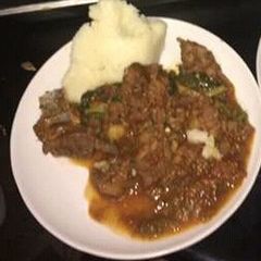 A picture of Beef stew served with Ugali.