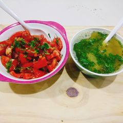 A picture of Mix vegetable soup with fresh Tomato salad.