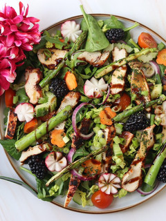 A picture of Spring time salad with harissa chicken.