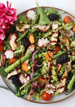 A picture of Spring time salad with harissa chicken.