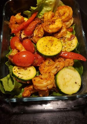 A picture of Shrimp zucchini on a bed of romaine lettuce.