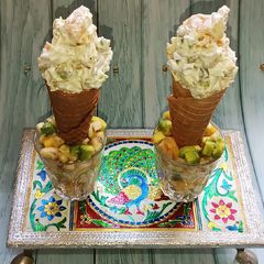A picture of Fruit salad in Ice cream cone.