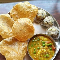 Aloo Matar ki sabji with puri A picture of Aloo Matar ki sabji with puri.