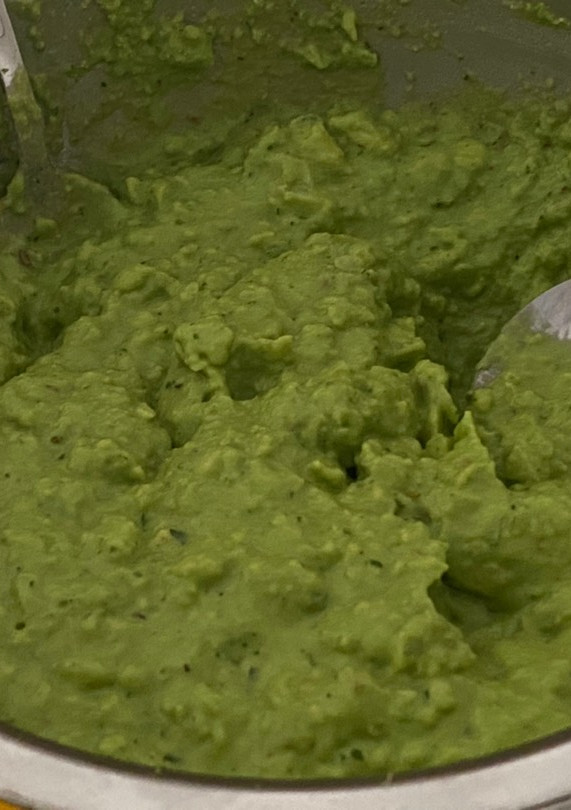 A picture of Guacamole with bread toast.