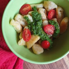 A picture of Homemade gnocchi with spinach pesto.