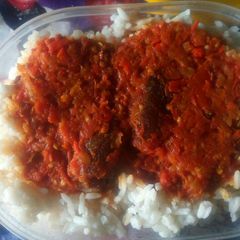 A picture of White rice with tomato stew.
