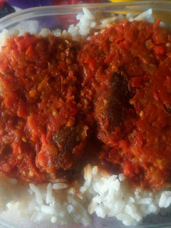A picture of White rice with tomato stew.