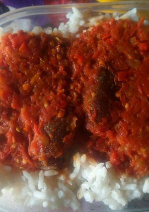 A picture of White rice with tomato stew.