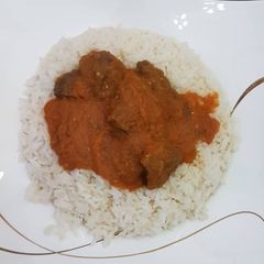 A picture of Beef Stew and rice.