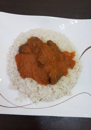 A picture of Beef Stew and rice.