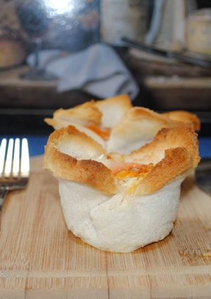 A picture of Eggs in bread basket.