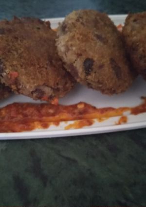 A picture of Arancini bean patty Mexican style.