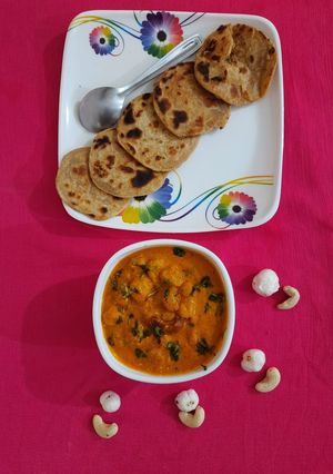 A picture of Besan masala stuffed mini paratha with cashew makhana curry.