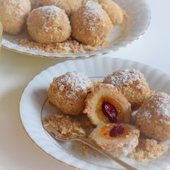 Apricot / cherry dumplings rolled in roasted almond breadcrumbs A picture of Apricot / cherry dumplings rolled in roasted almond breadcrumbs.