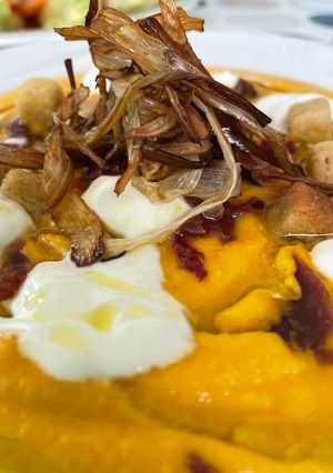Una foto de Crema de Calabaza con Espuma de Yogur, Calçots Crujientes y picatostes caseros