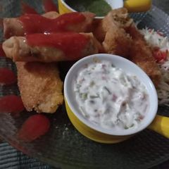 A picture of Chicken crumbed rolls and plain rolls.