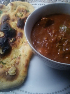 A picture of Beef Madras with garlic naan bread.