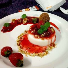 Strawberry panna cotta with caramelized peanuts A picture of Strawberry panna cotta with caramelized peanuts.