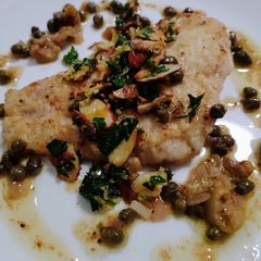 A picture of Lemon, caper, and olive fish with almond gremolata.