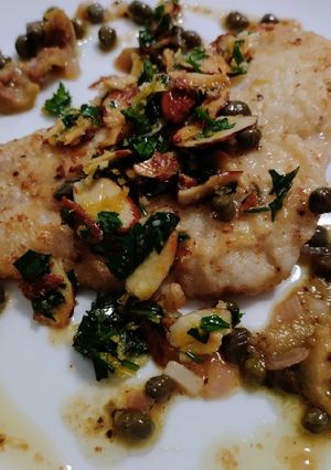 A picture of Lemon, caper, and olive fish with almond gremolata.