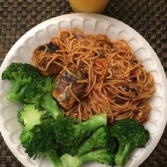A picture of Spagetti with fish and broccoli.