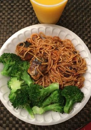 A picture of Spagetti with fish and broccoli.