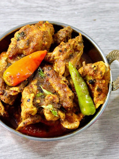 A picture of Golmorich Chicken Bengali style black pepper chicken.