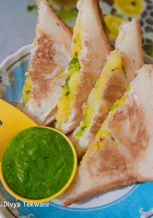 A picture of Potato stuffed sandwich with green chutney.
