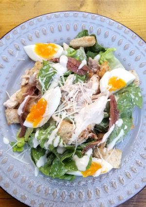 A picture of Beer can chicken Caesar salad skinny dressing version.