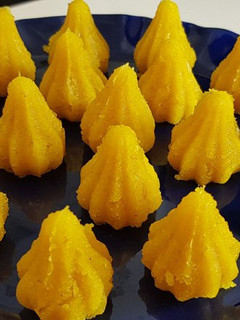 A picture of Kesari mawa modak | Yellow modak.