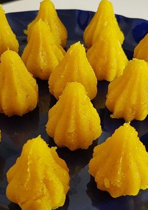 A picture of Kesari mawa modak | Yellow modak.